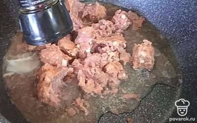 На сковороду разогретую выкладываем тушенку, перчим.