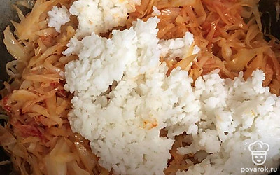 Добавьте вареный рис. Перемешайте все равномерно.