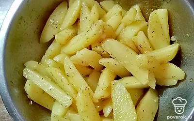 Слейте воду. Выложите картофельные дольки в миску с заправкой. Хорошо перемешайте.