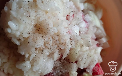 К фаршу добавить рис, соль, перец, лук. Перемешать.