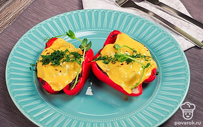 Готовый фаршированный перец украсьте мелко нарезанной зеленью петрушки.