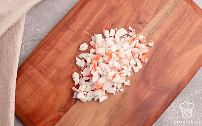 Мелко порубите крабовые палочки. Плавленый сырок натрите на мелкой терке.