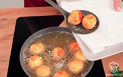 Обжарьте шарики. Налейте в сковороду с высокими бортами растительное масло и хорошо его разогрейте. Картофельно-сырные шарики обваляйте в муке и обжаривайте до тех пор, пока они не приобретут золотистый оттенок.