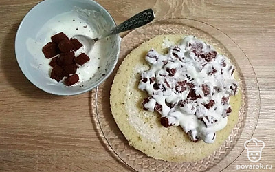 Соберите торт. На блюде установите основу для торта. По желанию слегка пропитайте ее сгущенным молоком, разведенным в небольшом количестве кипяченой воды. Обмазывая кусочки шоколадного коржа в креме, выкладывайте их на основу торта и формируйте «купол», плотно придавливая кусочки друг к другу. Сформированный торт покройте остатками крема и поместите в холодильник на ночь для пропитки.