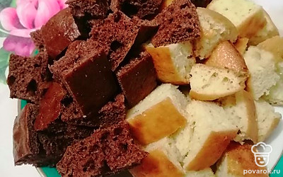 Смазываем форму для выпечки и выкладываем в неё одну часть теста и ставим в разогретую духовку на 180 градусов на 20 минут. Выпекаем вторую часть теста. После того, как белый корж остынет ,режем его на равные кусочки примерно 2 см. У шоколадного коржа срезаем верхний слой. 