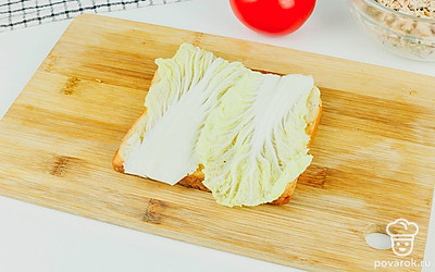 Поджарьте хлеб в тостере или на сковороде. Смажьте его тонким слоем сливочного масла и выложите на масло лист пекинской капусты.