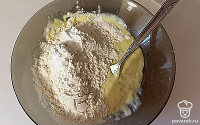 К жидкой смеси просейте 100 грамм муки и добавьте разрыхлитель. 