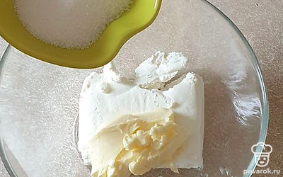 В миску выложите творог. К нему добавьте мягкое сливочное масло, ванилин, сахар. Хорошо все перемешайте.