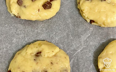 Скатайте из теста круглые печеньки и разложите на пергамент. Украсьте печеньки с верху оставшимися шоколадками. Выпекайте в разогретой духовке 15 минут при 180 градусах. Приятного аппетита!
