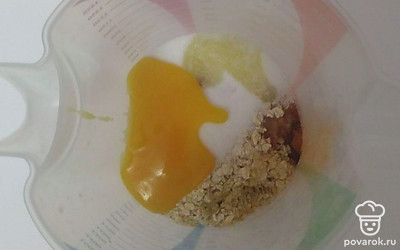 Смешайте в глубокой миске сахар, ванильный сахар, мед, муку, овсяные хлопья, оливковое масло, масло мандарина, имбирь, перец душистый, гвоздику, корицу, разрыхлитель и воду. Можете взбить все блендером до однородной массы, но также отлично можно перемешивать и веничком.