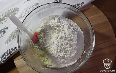 Добавьте к маслу просеянную муку, аккуратно перемешайте лопаткой или на низкой скорости миксера.