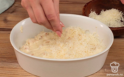 Куриное филе со сливочным соусом разложите по кокотницам, присыпьте тертым сыром и запекайте в разогретой до 180°С духовке около 10 минут до появления на поверхности сыра румяной корочки.