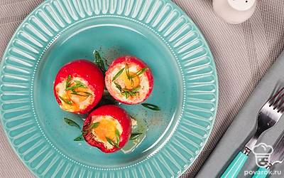 Помидоры, фаршированные яйцом, выложите на сервировочную тарелку и посыпьте нарезанным зеленым луком.