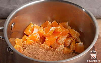 Выложите мандарины в кастрюлю или сотейник. Засыпьте их сахаром и оставьте на 3-4 часа, чтобы они пустили сок.