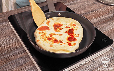 Положите хачапури с сулугуни на сковороду, накройте крышкой и жарьте на медленном огне минут 8, пока тесто не схватится сверху. Переверните. Жарьте еще минуты 3, пока тесто не станет румяным. Положите готовую лепешку на блюдо и смажьте кусочком сливочного масла.