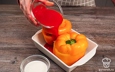 Нафаршируйте перцы и запеките их в духовке. Начините перец готовой овощной смесью. Накройте верхней срезанной частью с плодоножкой. Вертикально выставьте на жаропрочную форму начиненный перец. В чашке смешайте томатный соус с водой и залейте перецы. Запеките блюдо в разогретой до 180 градусов духовке в течение 30-35 минут.