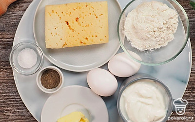 Расположите удобно все продукты. Заранее натрите сыр на терке. Разморозьте масло, чтобы оно стало мягким. Приготовьте глубокую миску. Достаньте сковороду с крышкой, смажьте ее растительным маслом. Просейте муку через сито. Вымойте зелень.