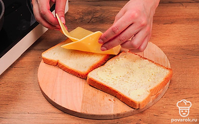 Выложите сыр (можно в 2 слоя) на один ломтик хлеба (на сторону, которую вы не смазали маслом). Другим ломтиком хлеба закройте сыр сверху (маслом наружу).