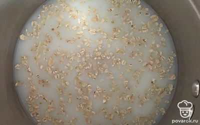 В молоко высыпаем овсянку и манную крупу. Добавляем соль и сахар. Варим до готовности.