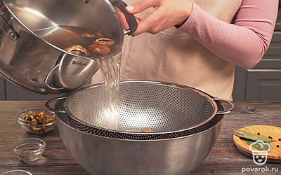 Сварите грибы. Поставьте кастрюлю с холодной водой на плиту. Положите в нее грибы. Когда вода закипит, снимите пену шумовкой. Уменьшите огонь, накройте крышкой и варите 20 минут. Откиньте грибы на дуршлаг и оставьте в раковине, чтобы стекла вода.