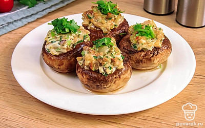 Добавьте в начинку сыр, так шампиньоны станут еще вкуснее. Полейте блюдо соусом терияки и посыпьте кунжутом.