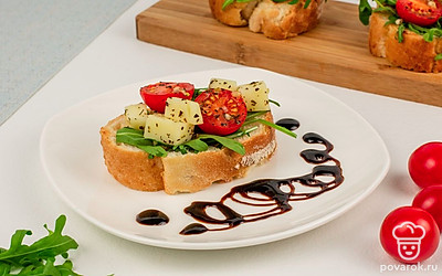 Готовые брускетты выложите на тарелку и сбрызните крем-бальзамиком.