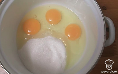 В кастрюлю разбиваем яйца и добавляем сахар. 