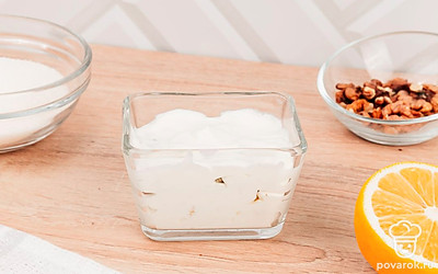 В десертные креманки выложите ингредиенты, начиная со взбитых сливок, чередуя с ними каждый слой: бисквит, грецкие орехи, безе, банан и закончите верхний слой взбитыми сливками.