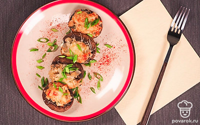 Перед подачей шампиньоны, фаршированные курицей, посыпьте зеленью петрушки и лука.