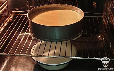 Духовку разогрейте до 180 градусов. Железную миску с кипятком поставьте на дно духового шкафа. Форму с чизкейком поставьте на решетку. Выпекайте 30 минут при 180 градусах в режиме «верх-низ». Затем огонь уменьшите до 160 градусов и выпекайте еще 30 минут. 