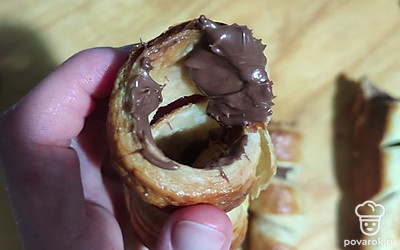 Теперь возьмём наш крем, нальём его в кондитерский мешок, чтобы было удобнее наполнять трубочки. Каждую трубочку смазываем изнутри чайной ложкой нутеллы.