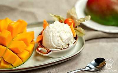 С помощью ложки для мороженого сформируйте небольшие шарики, переложите их в пиалу или креманку. Украсьте блюдо листьями мяты и цукатами из манго.