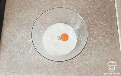 В миску вбейте яйцо, влейте молоко. 