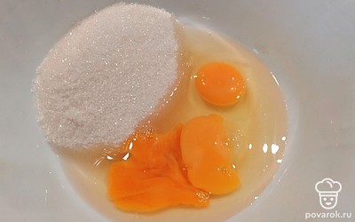 В миску вбейте яйца. Добавьте сахар и соль, хорошо взбейте. 