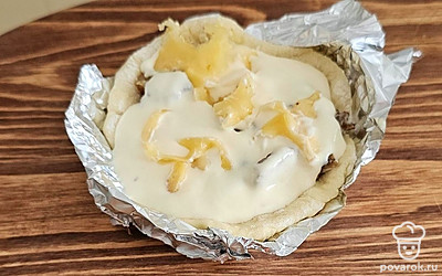 Залейте соусом и посыпьте тертым сыром. 