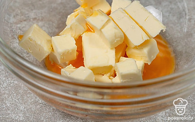 Нарежьте 150 г холодного масла кубиками, переложите их в миску. Отделите желток от белка, положите желток к маслу. 