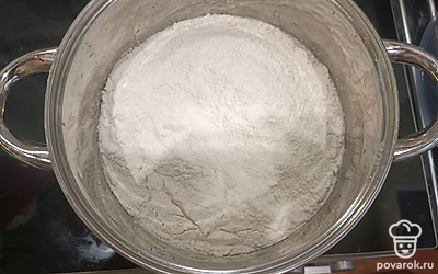 После образования шапочки немного перемешать венчиком, добавить 600 граммов просеянной муки и замесить тесто.