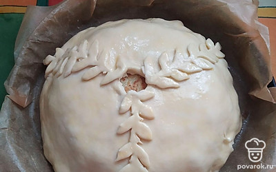 Верхний пласт теста должен быть диаметром больше нижнего на 1,5-2 сантиметра. Накрыть курник, защипнуть хорошо края внизу. Сверху оставить отверстие для выхода пара, смазать яйцом.