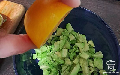 Полейте авокадо лимонным соком и перемешайте.