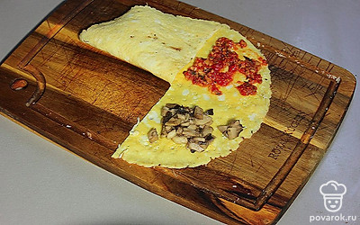 На вторую половину выложите соус и грибы.