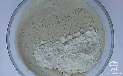 Продолжая взбивать, добавьте кефир комнатной температуры, растопленное сливочное масло и разрыхлитель. Затем, просейте в жидкую массу муку и еще раз взбейте тесто миксером на небольших оборотах. Тесто должно получиться консистенции густой сметаны.