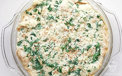 Сверху пирог смажьте приготовленной сметано-яичной смесью, присыпьте семенами кунжута. Отправьте пирог запекаться в разогретую духовку до 200 °C на 25 минут.