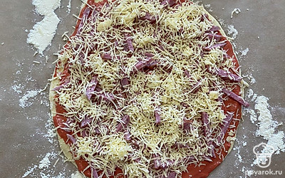 Присыпьте им равномерно всю пиццу.