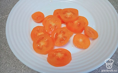 Нашинкуйте желтые помидоры кружочками.