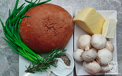 Промойте и мелко нарежьте шампиньоны. Сыр нарежьте пластинками. Сливочное масло нарежьте на бруски. Зеленый лук промойте и мелко нарежьте. Буханку хлеба нарежьте сверху на квадратики.