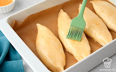 Разогрейте духовку до 180°С. Застелите противень пекарской бумагой. Выложите на него заготовки на небольшом расстоянии друг от друга. Смажьте поверхность теста яичным желтком и отправьте выпекаться на 35 минут.