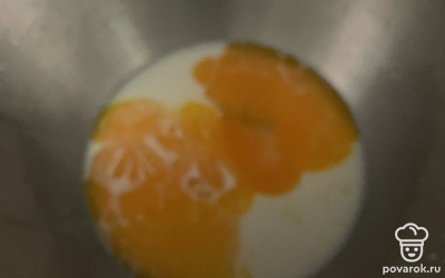 В емкости смешайте теплое молоко, яичные желтки, дрожжи и сахар.