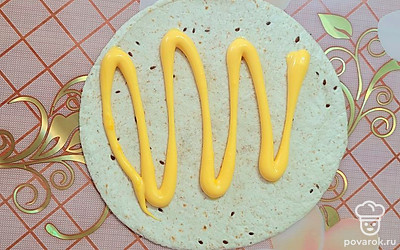 Поверхность тортильи смазать сырным соусом. 