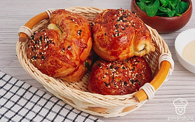 Готовых улиток из слоеного теста со шпинатом подавайте к столу.