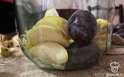 Нарежьте яблоки. Яблоки и сливы выложите в банку объемом 3 литра.